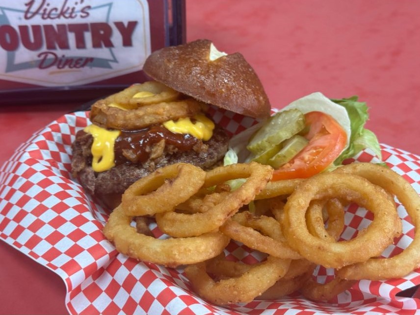 Smokehouse Stacked Burger and batter fried onion rings on a diner plate.