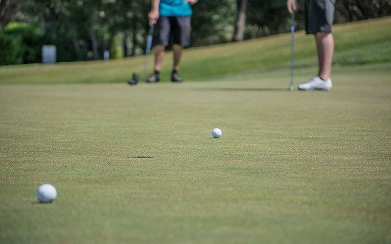 white golf balls on green